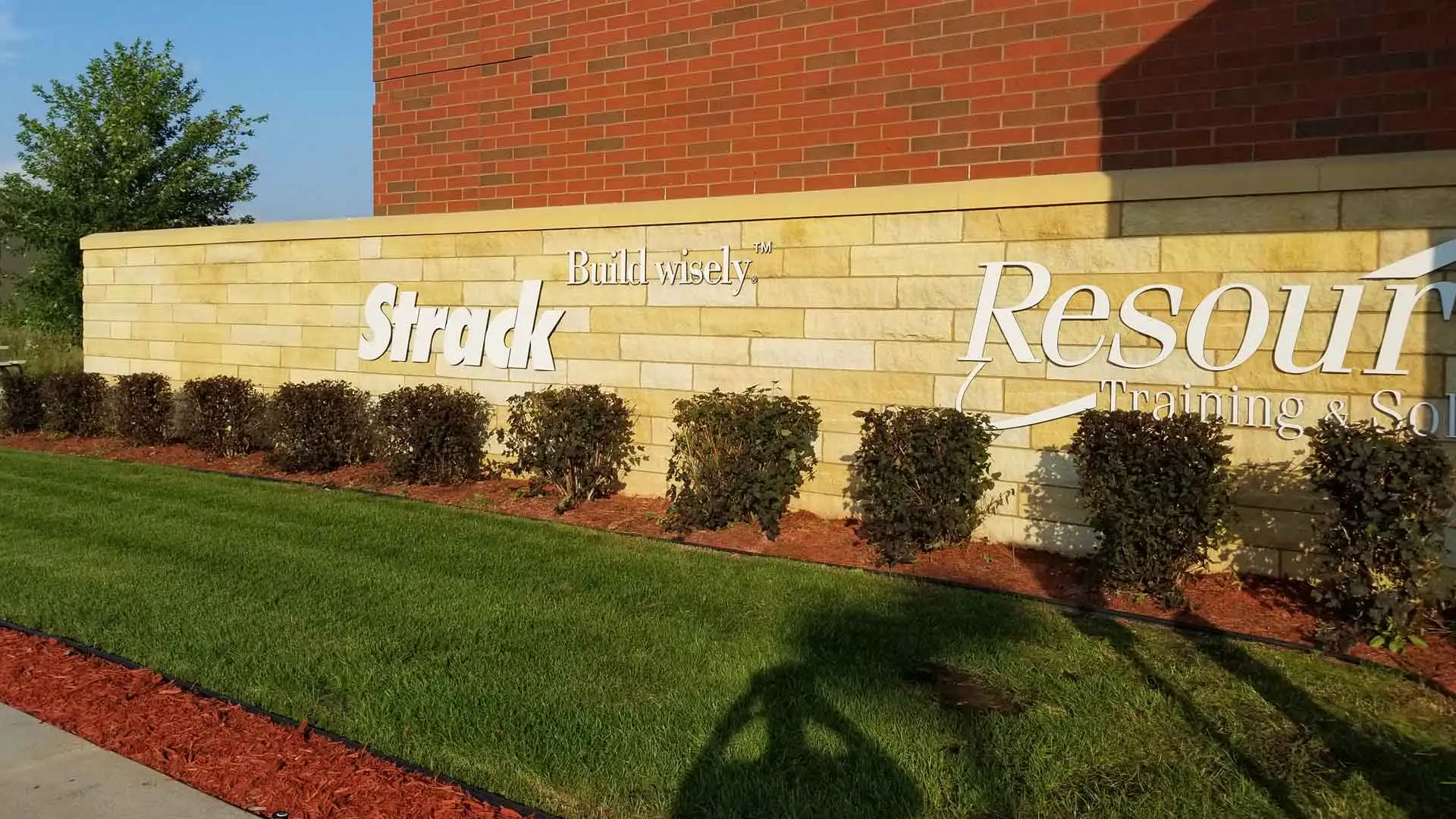 Perfectly trimmed shrubs in front of a commercial building in Sauk Rapids.