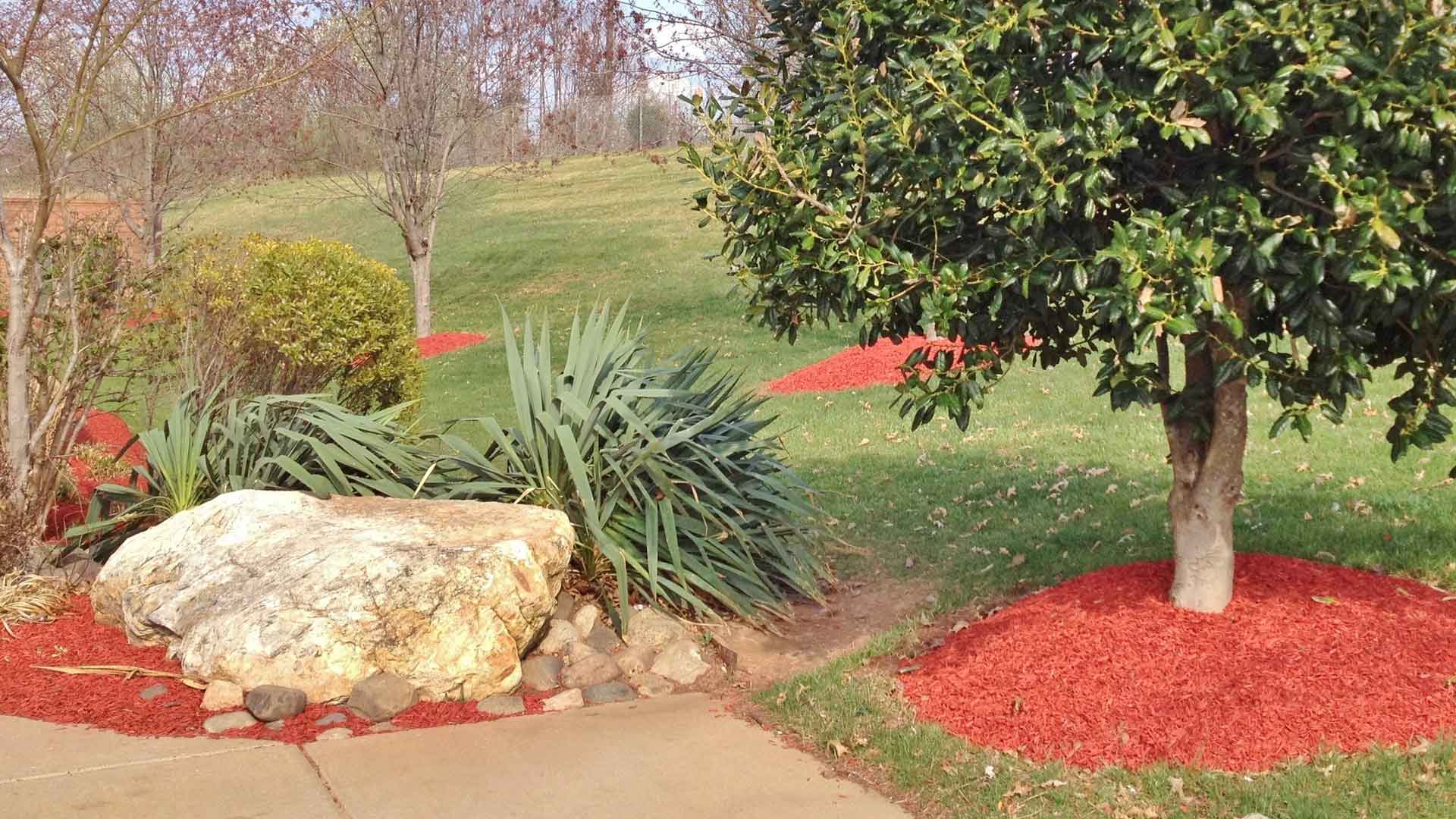 Red mulch installed in landscaping beds at a home in Sartell.